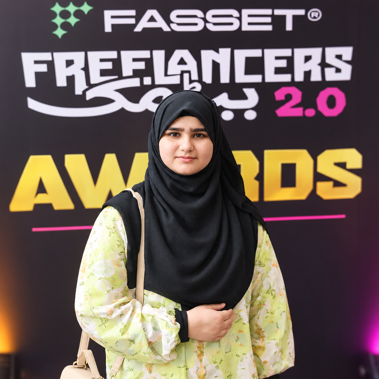 Hoorain Ansari in front of the Freelancers Baithak 2.0 awards backdrop